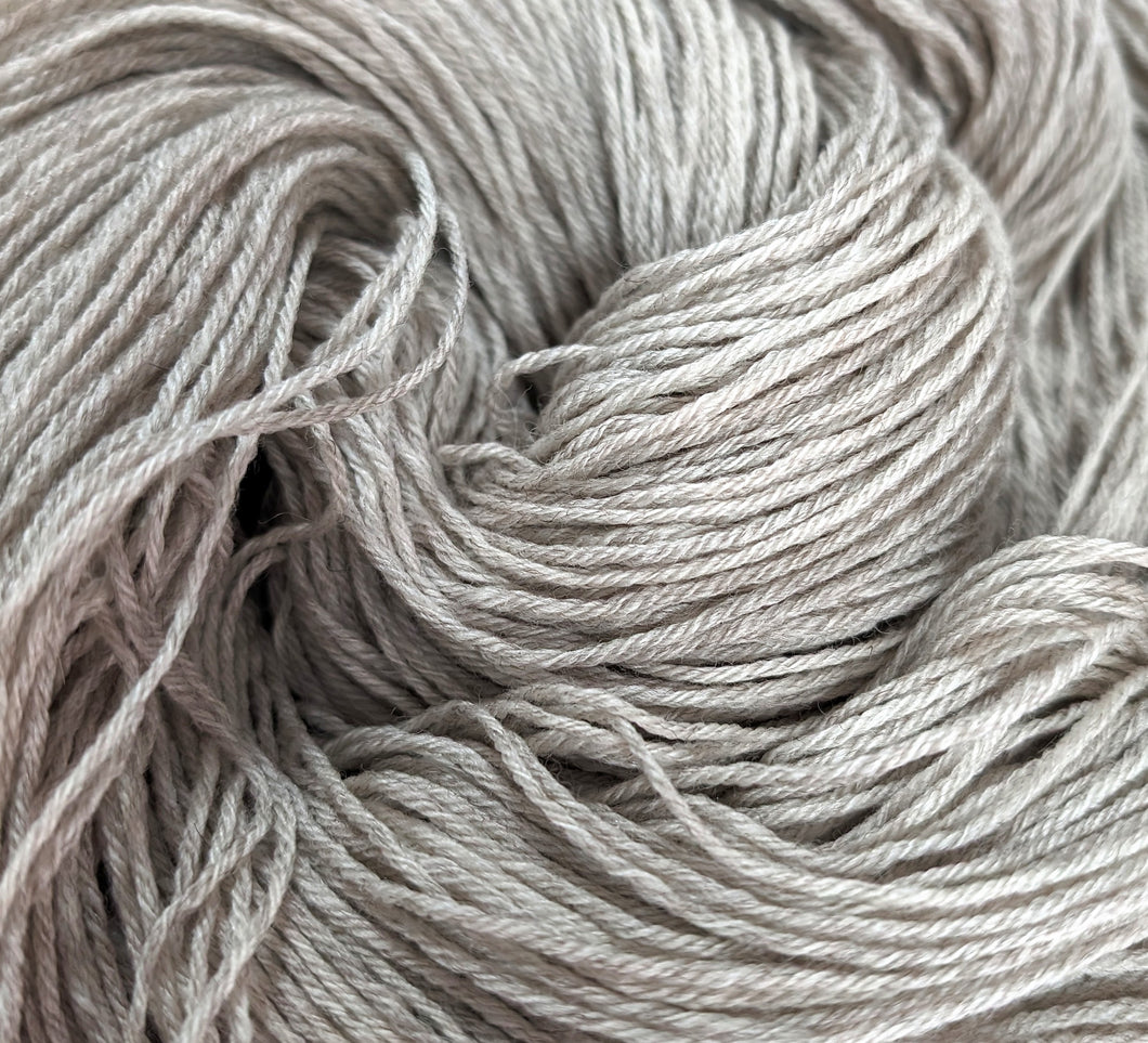 Undyed Cormo/silk 4ply/fingering weight.