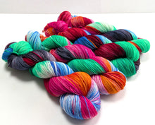 Load image into Gallery viewer, Multicolored skeins of yarn on a white background