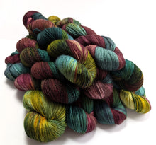 Load image into Gallery viewer, Multicolored skein of yarn on a white background