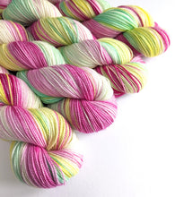 Load image into Gallery viewer, A Christmas Rose on superwash Merino/nylon/sparkle sock yarn.
