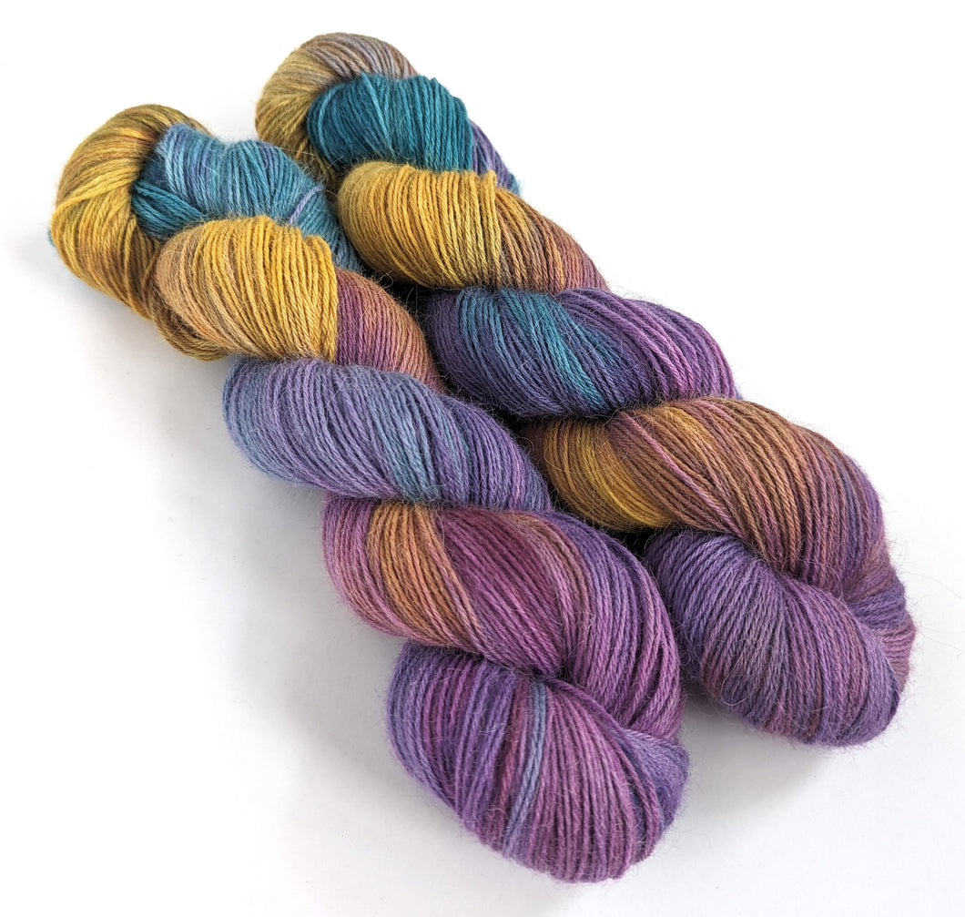 Awaken on 100% llama 4ply/fingering weight yarn. Natural base.