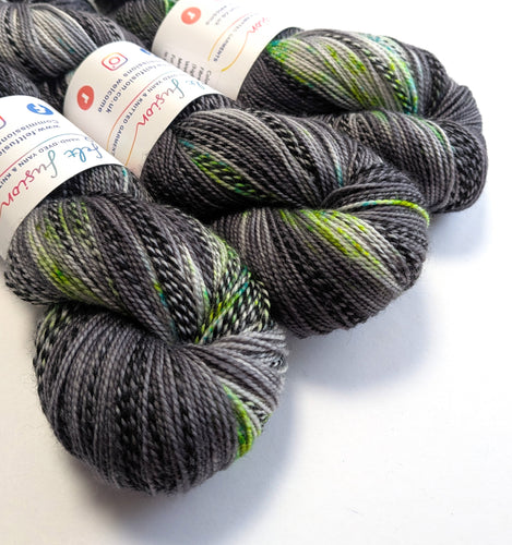 Gray and green yarn skeins with labels on a white background
