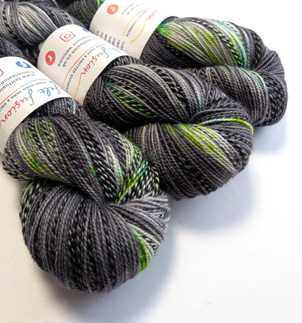 Gray and green yarn skeins with labels on a white background