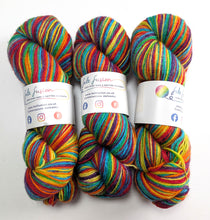 Load image into Gallery viewer, Three skeins of rainbow yarn on a white background.
