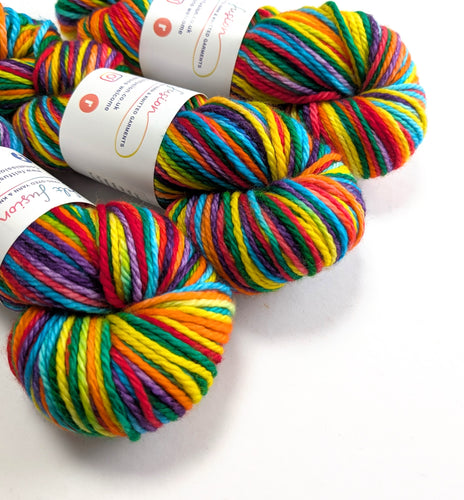 Three skeins of colorful yarn on a white background