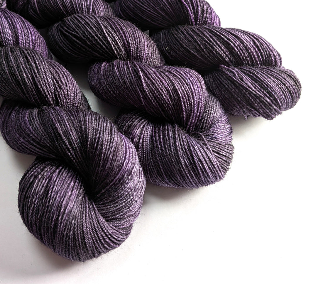 Purple yarn skeins on a white background
