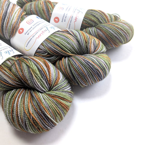 Three skeins of multicolored yarn with labels on a white background