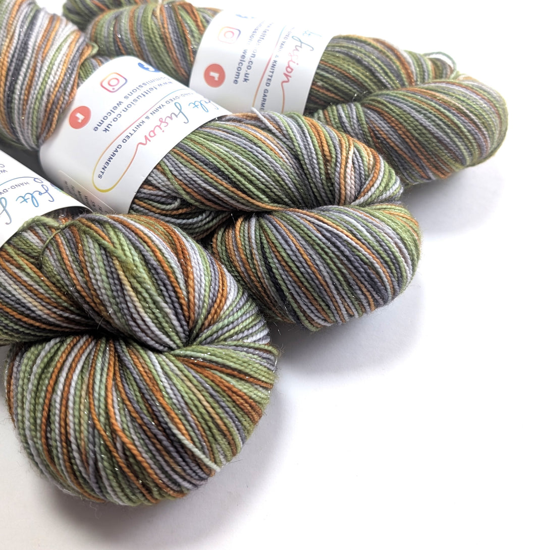 Three skeins of multicolored yarn with labels on a white background
