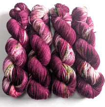 Load image into Gallery viewer, Four skeins of purple yarn with multicolor speckles on a white background
