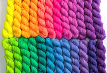 Load image into Gallery viewer, Colorful yarn skeins arranged in a rainbow pattern on a white background
