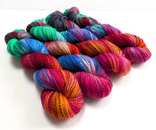 Load image into Gallery viewer, Colourful skeins of yarn on a white background
