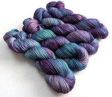 Load image into Gallery viewer, Four skeins of purple and blue yarn.

