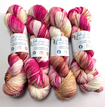 Load image into Gallery viewer, Four skeins of multicolored yarn with visible branding on a white background
