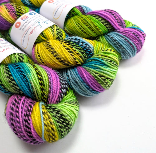 Colorful skeins of yarn with labels on a white background