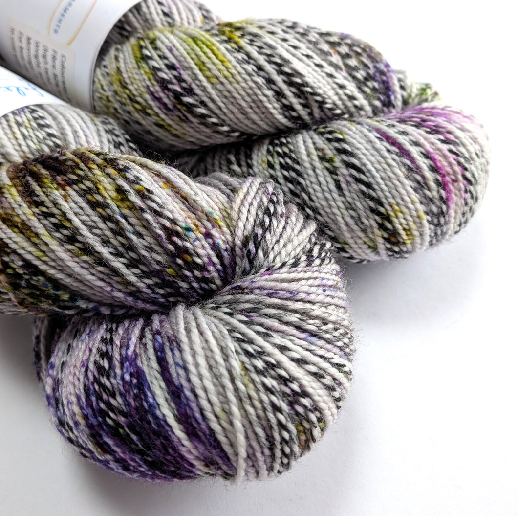 Two skeins of multicolored yarn on a white background