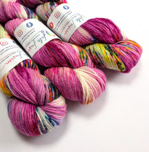 Load image into Gallery viewer, Three skeins of variegated yarn from Felt Fusion, featuring a mix of magenta, pink, purple, yellow, green, and cream colours, arranged on a clean white background.
