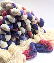 Load image into Gallery viewer, Multicolored yarn skeins on a white background

