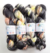 Load image into Gallery viewer, Four skeins of multicolored yarn with labels on a white background
