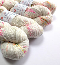 Load image into Gallery viewer, Spotted yarn skeins with visible branding on a white background
