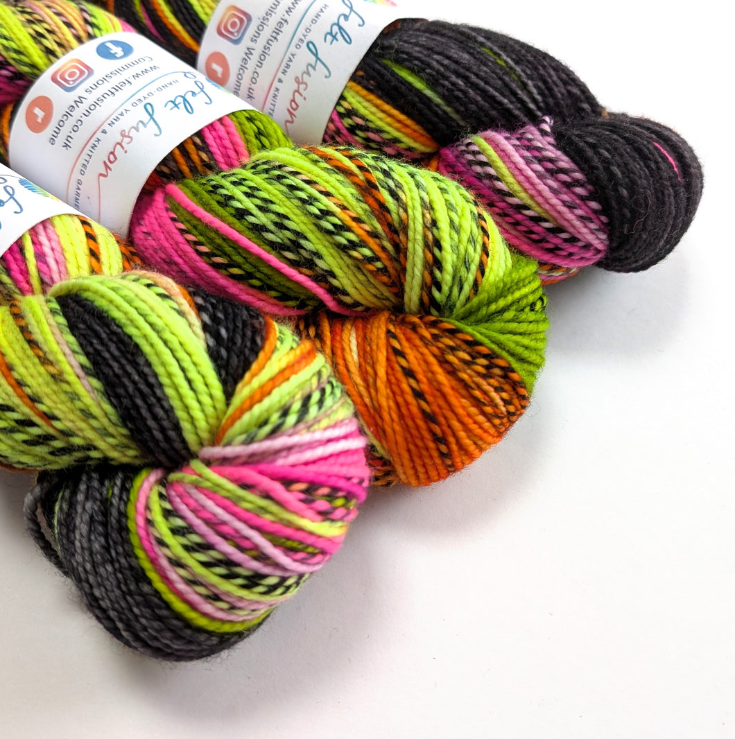 Colorful skeins of yarn with labels on a white background