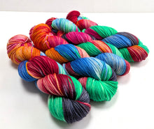 Load image into Gallery viewer, Multicolored yarn skeins on a white background
