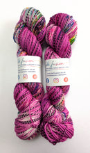 Load image into Gallery viewer, Two skeins of multicolored yarn with visible brand labels on a white background
