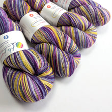 Load image into Gallery viewer, purple and yellow yarn skeins with labels on a white background
