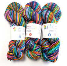 Load image into Gallery viewer, Three skeins of colorful yarn with labels on a white background

