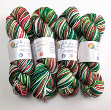Load image into Gallery viewer, Four skeins of multicoloured yarn with visible brand labels on a white background

