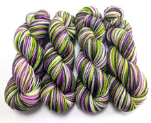 Load image into Gallery viewer, Colorful yarn skeins with purple, green, and white on a white background

