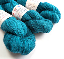 Load image into Gallery viewer, Three skeins of blue-green yarn with labels on a white background
