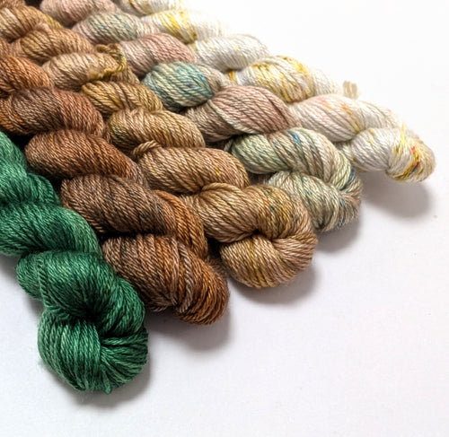 Set of colorful yarn skeins on a white background