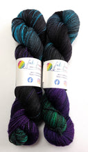 Load image into Gallery viewer, Two skeins of multicolored yarn with labels on a white background

