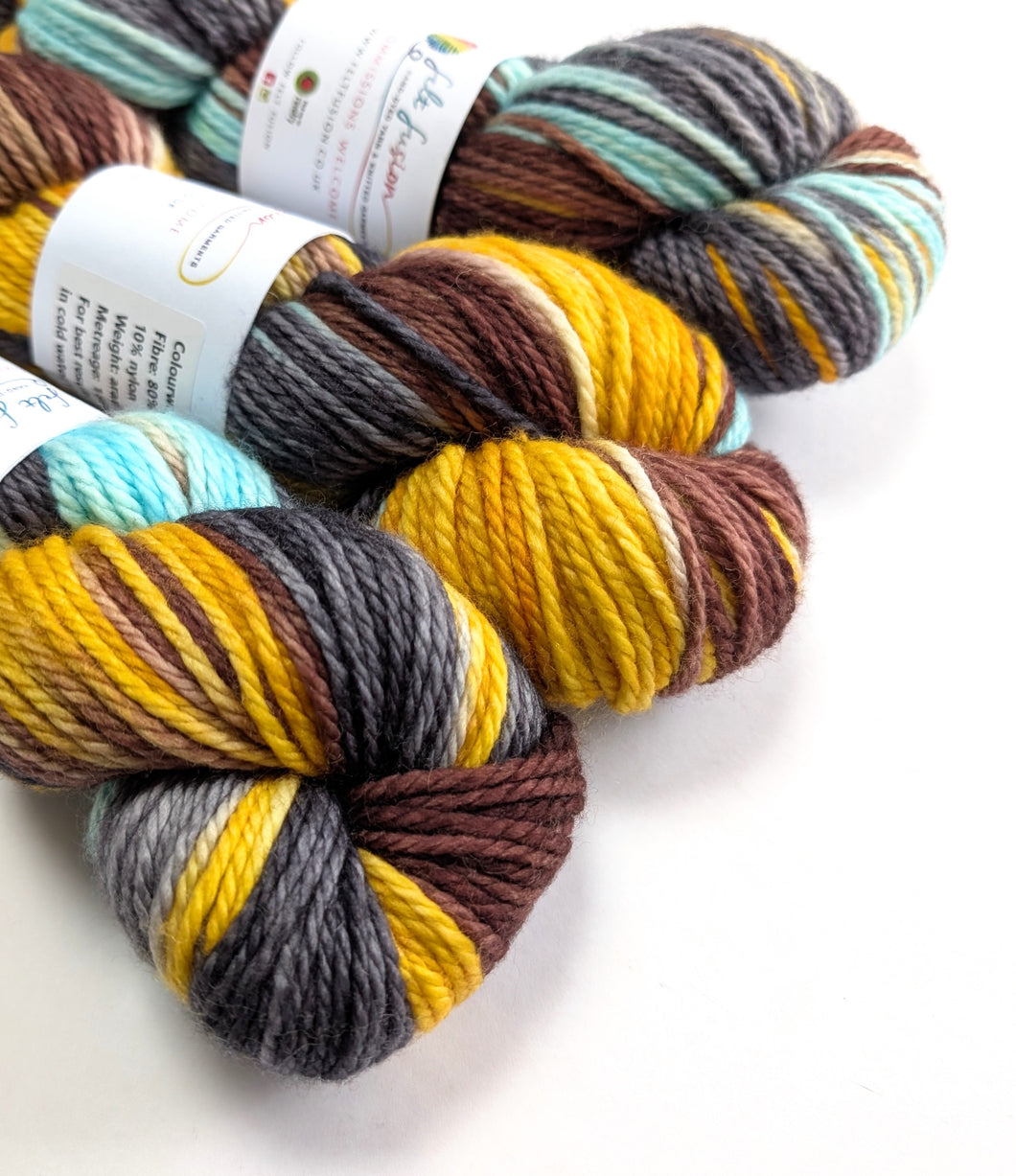 Three skeins of multicolored yarn with labels on a white background