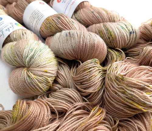 Close-up of skeins of yarn in various shades of brown and beige.