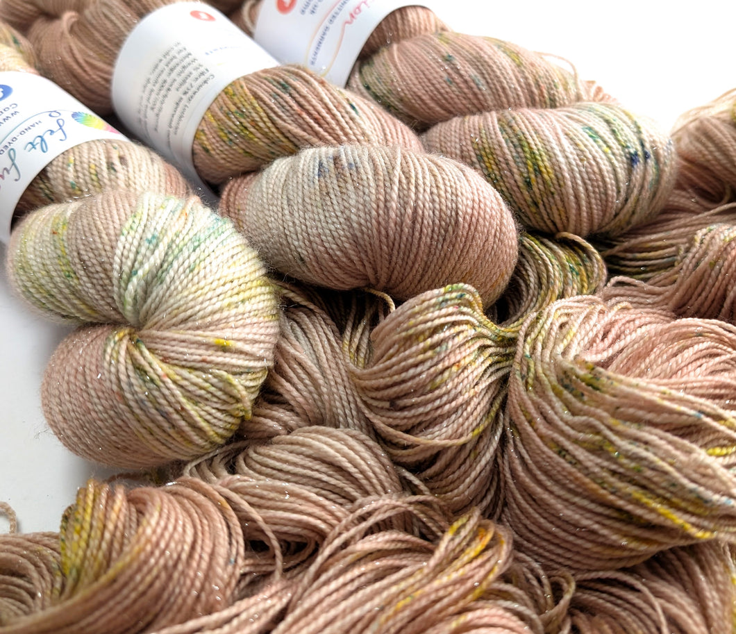 Close-up of skeins of yarn in various shades of brown and beige.