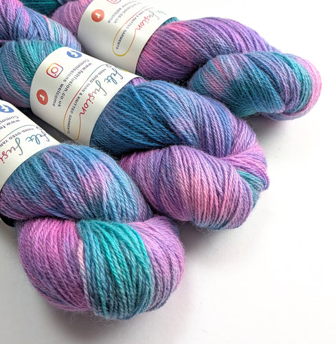 Multicolored yarn skeins with labels on a white background