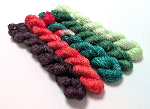 Set of colorful yarn skeins on a white background