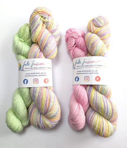 Two sets of multicolored pastel yarn on a white background