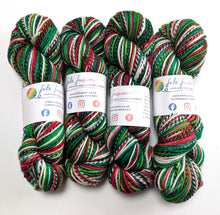 Load image into Gallery viewer, Four skeins of multicolored yarn with visible brand labels on a white background
