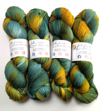 Load image into Gallery viewer, Four skeins of green and gold yarn.
