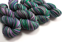 Load image into Gallery viewer, Purple and green yarn skeins on a white background
