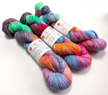 Load image into Gallery viewer, Ironic on 100% llama 4ply/fingering weight yarn. Off-white base.

