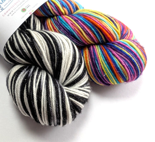 Black and white and multicoloured skeins of yarn. 