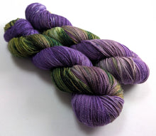 Load image into Gallery viewer, Two skeins of purple and green yarn on a white background
