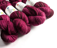 Load image into Gallery viewer, Skeins of deep pink yarn with visible labels on a white background
