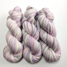 Load image into Gallery viewer, Three skeins of multicolored yarn on a white background
