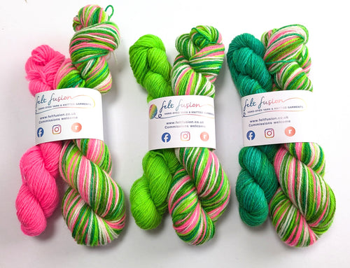 Three sets of colorful yarn with labels on a white background
