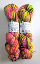 Load image into Gallery viewer, Two skeins of colourful yarn with multicolour pattern on a white background
