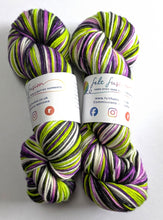 Load image into Gallery viewer, Two skeins of multicoloured yarn with visible branding on a white background
